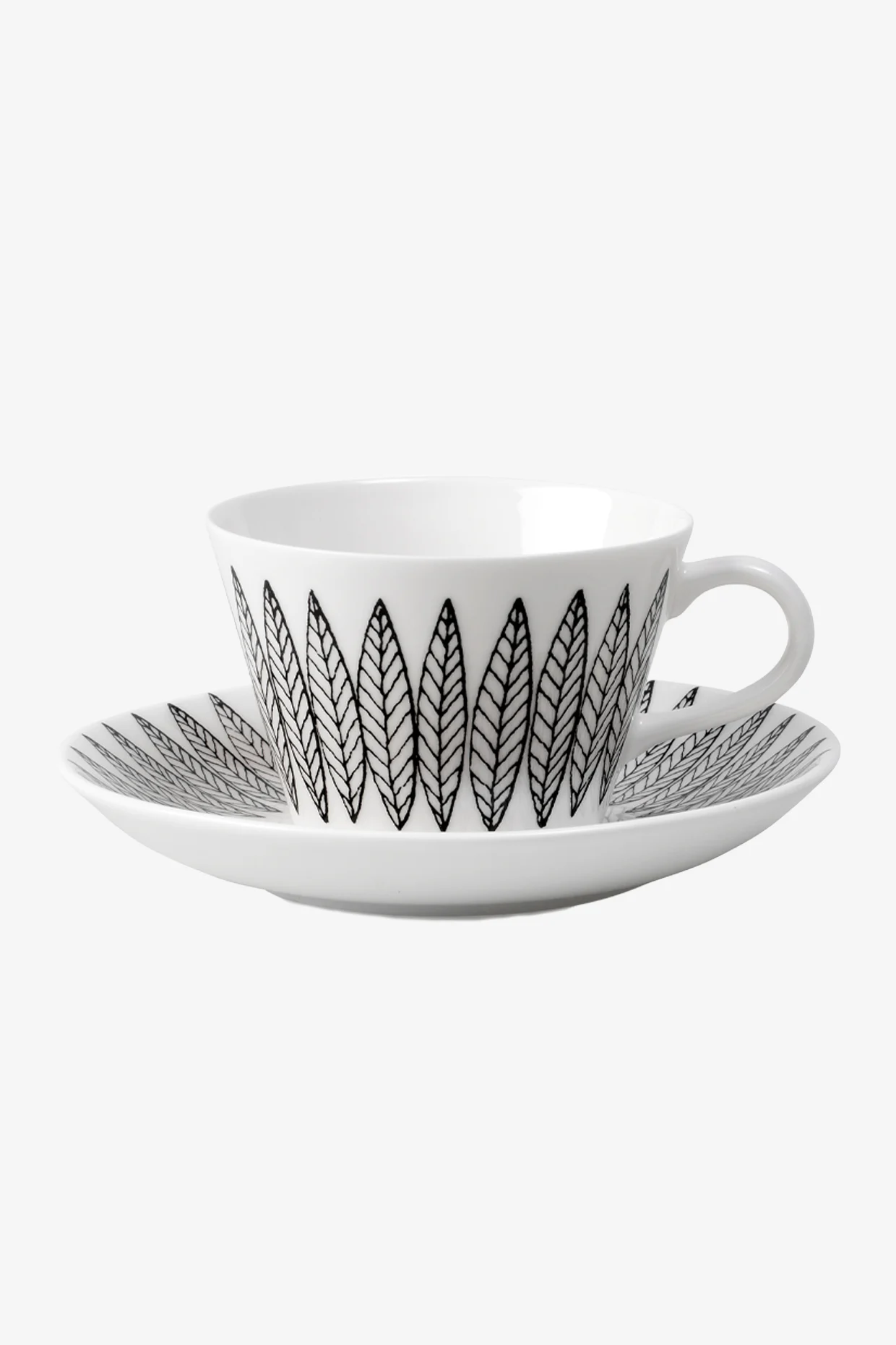 White teacup and saucer with black leaf pattern.