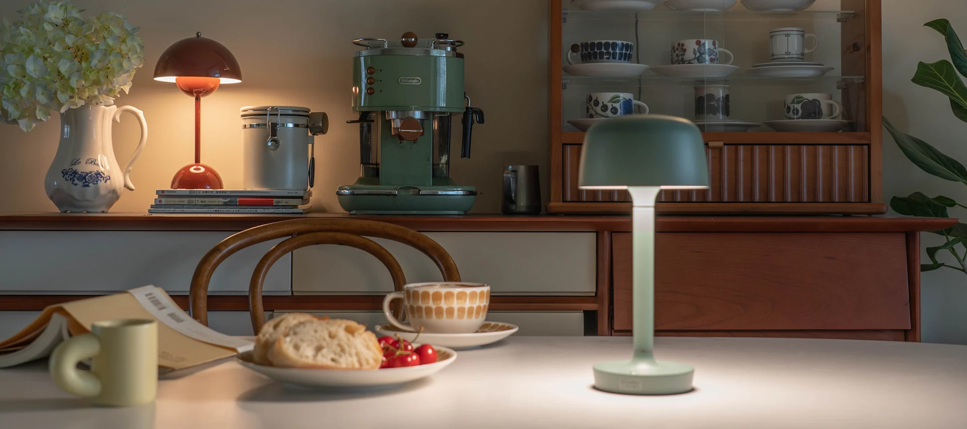Decorate with rechargeable lamps outdoors to create a cosy patio or garden, here Halo portable lamp from Scandi Living and Flowerpot from &Tradition.