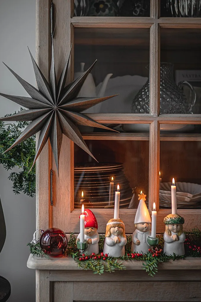 The adorable Advent Children candle holders standing on a display cabinet, collectables make a great Christmas gift idea. 