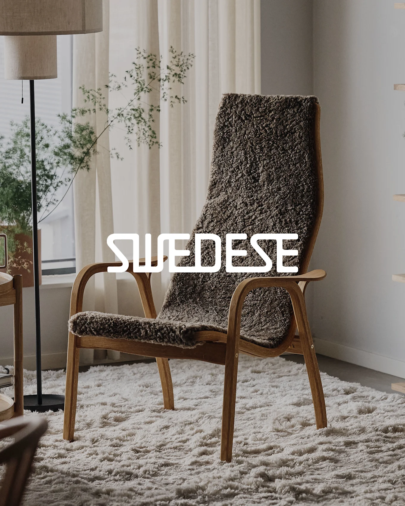 SWEDESE brand name over a wooden armchair with brown shaggy upholstery on a white rug.