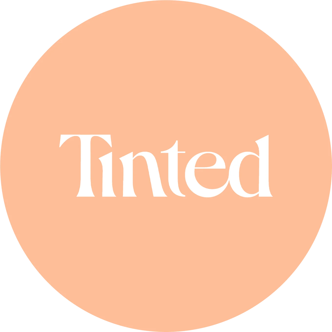 The word 'Tinted' in white, serif font, against a circular light orange background.