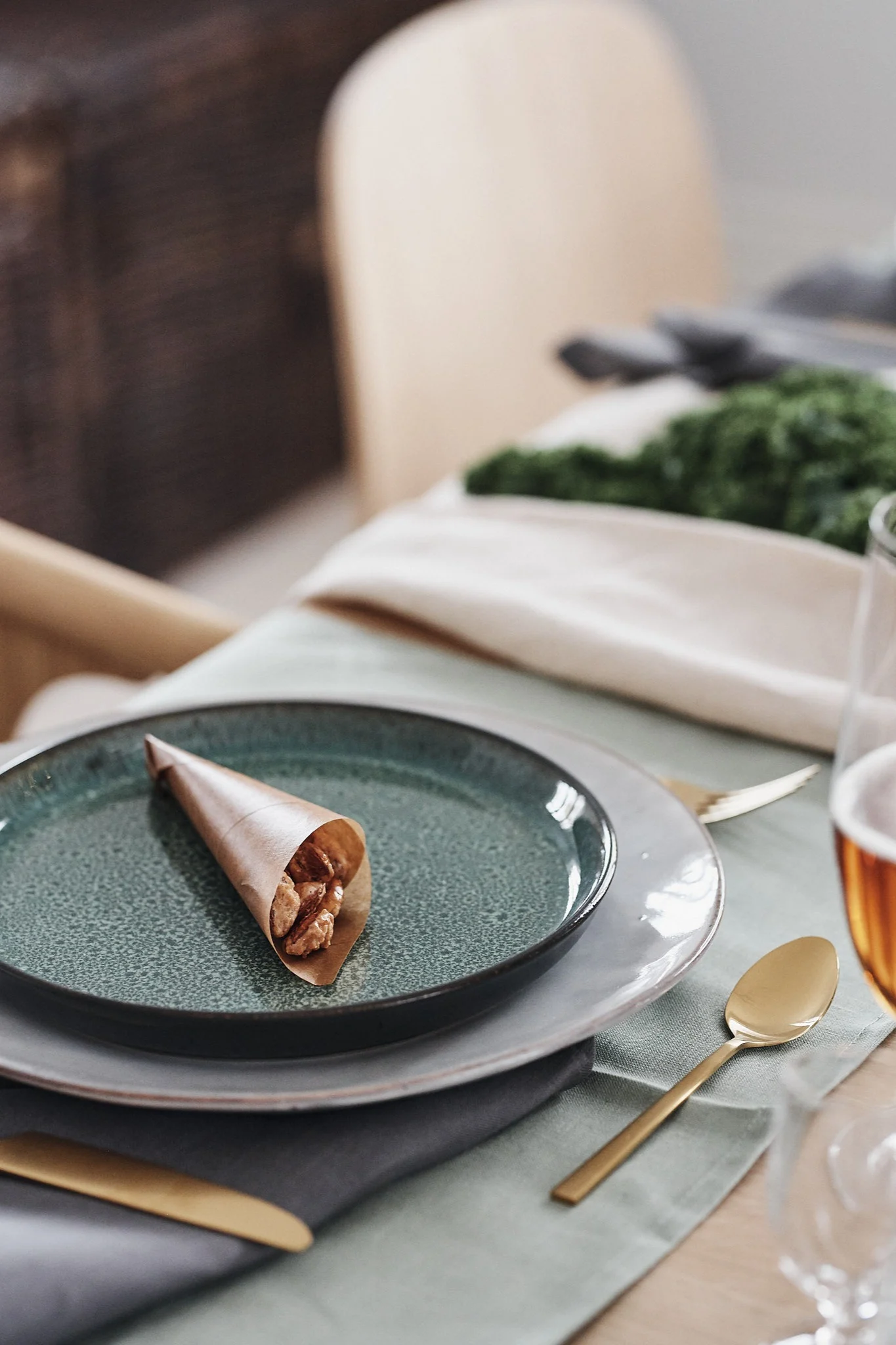 A paper bag with candied almonds on the plate will be a sweet decoration on the Christmas table.