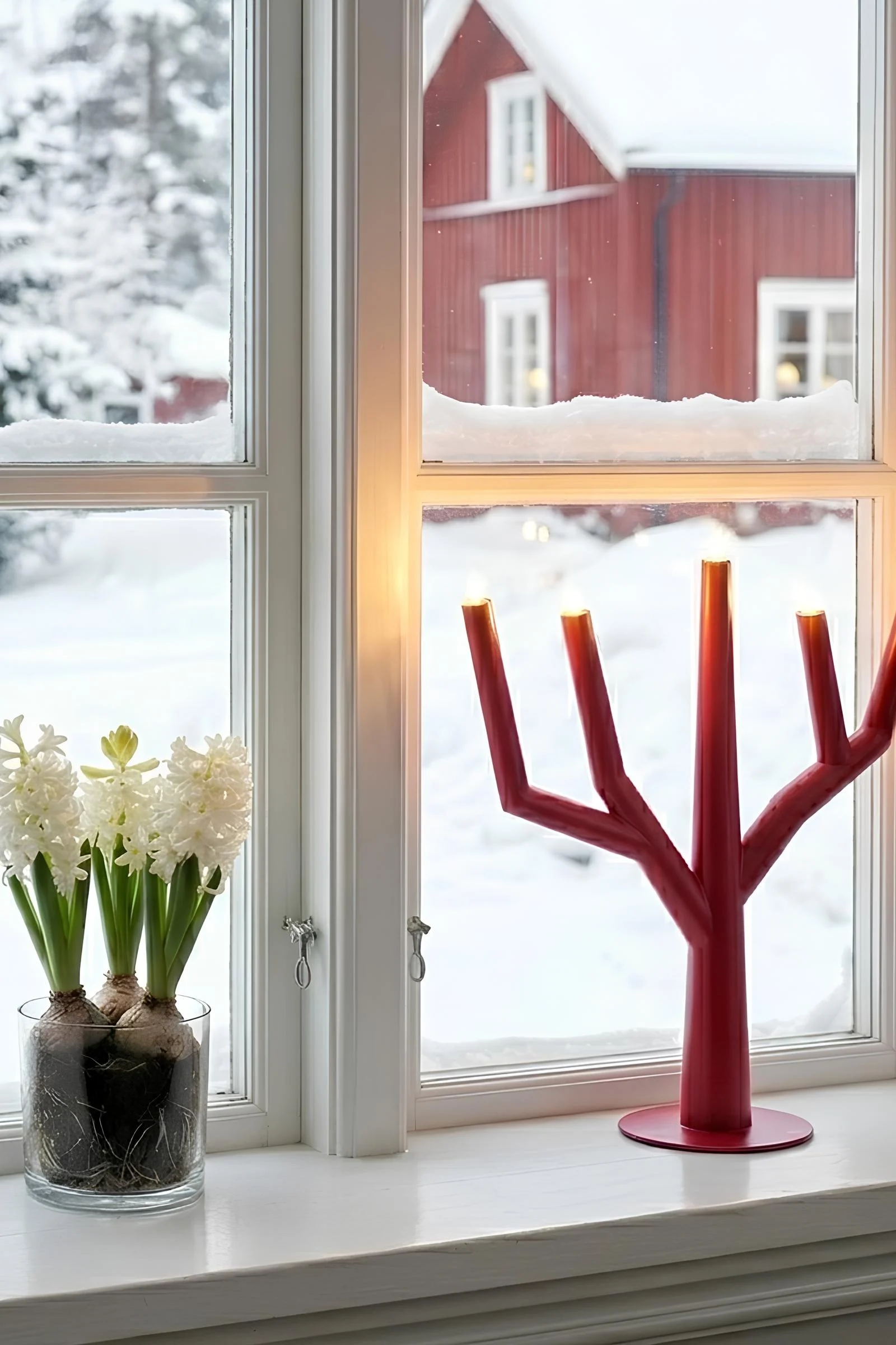 The Arrow Christmas candle arch from Star Trading in white stands on a sideboard. 