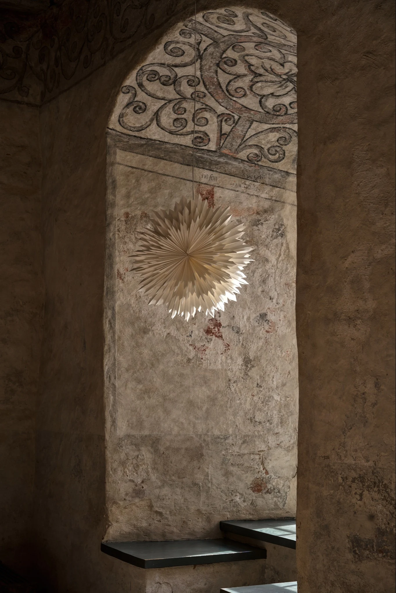The Christmas star Ice from Star Trading hangs in a pair against a grey wall.